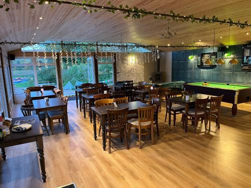 a dining room with tables and a pool table at Country View Camping in Bratton