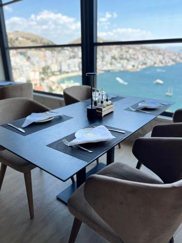 a blue table in a restaurant with a view at Toer Hotel & SPA in Sarandë