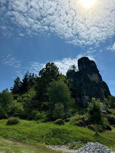 a rock formation in the middle of a field at Pobytový domček Studničná in Komjatná