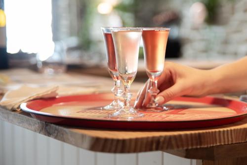two glasses of champagne on a plate on a table at hôtel TY RU in Riec-sur-Bélon