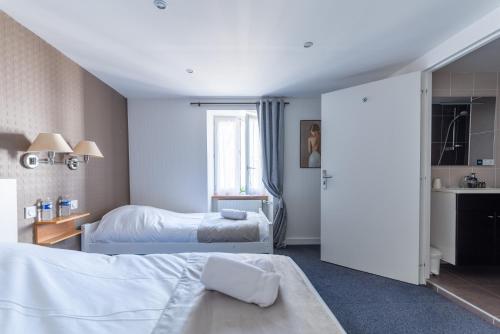 a hotel room with two beds and a window at hôtel TY RU in Riec-sur-Bélon