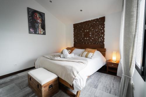 a bedroom with a large bed with a wooden headboard at Loft 150 m2 Jacuzzi, Sauna et Massage in Blagnac