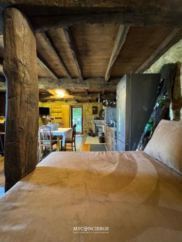 a large bed in a room with a kitchen at Vista Verde Lodge in Vale de Cambra