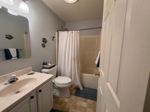 a bathroom with a sink and a toilet and a shower at River Gem: Spacious 4 Bdrm Beach House 2 Blocks to Beach in Colonial Beach
