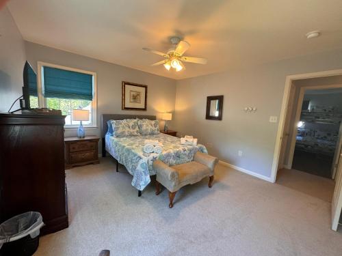 a bedroom with a bed and a ceiling fan at River Gem: Spacious 4 Bdrm Beach House 2 Blocks to Beach in Colonial Beach