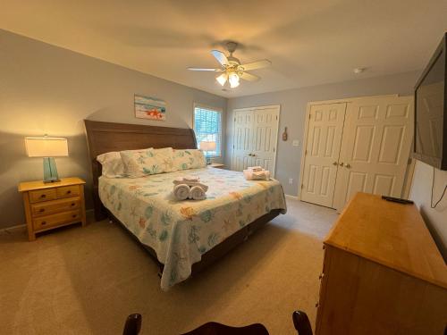 a bedroom with a bed with a stuffed animal on it at River Gem: Spacious 4 Bdrm Beach House 2 Blocks to Beach in Colonial Beach