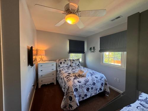 a bedroom with a bed and a ceiling fan at River Gem: Spacious 4 Bdrm Beach House 2 Blocks to Beach in Colonial Beach
