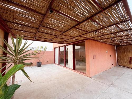 an outdoor patio with a wooden ceiling and a plant at Iconic Home DLF New Chandigarh in Mohali