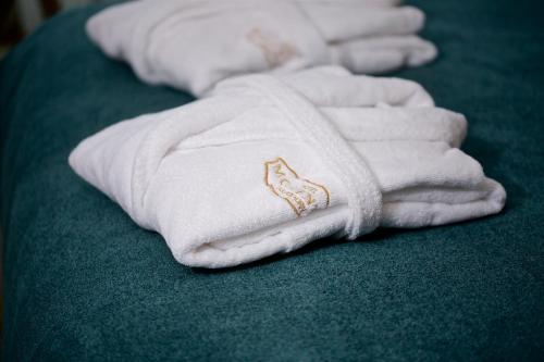 a group of white towels sitting on a bed at Hotel Momento Golden Horn in Istanbul