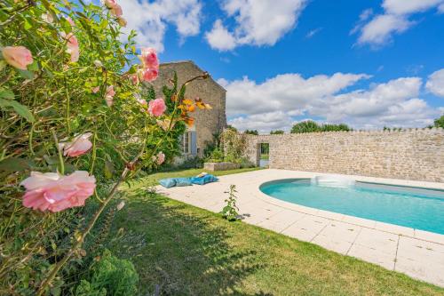 un jardin avec piscine à côté d'un bâtiment en pierre dans l'établissement Maison de vacances avec piscine, à Sainte-Gemme