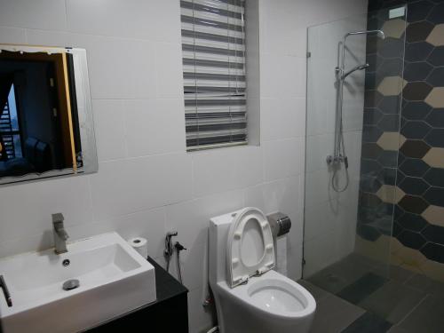 a bathroom with a sink and a toilet and a shower at vivacity megamall jazz suites 2 kuching in Kuching