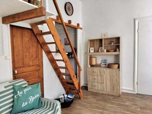 a staircase in a living room with a wooden door at Au pied du Baou in Saint-Chamas