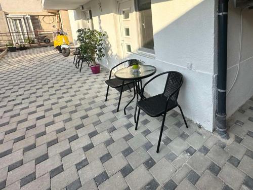 a patio with a table and chairs on a sidewalk at Julia Apartments in Ohrid