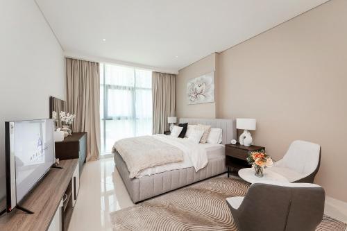 a bedroom with a bed and a flat screen tv at Popular Seven Palm Apartments in Dubai