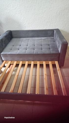 a couch sitting on top of a wooden floor at Apê210MiguelPereira in Miguel Pereira