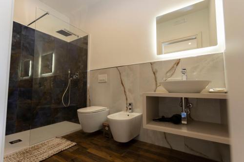a bathroom with a toilet and a sink and a shower at San Francesco Tropea Accomodation in Tropea