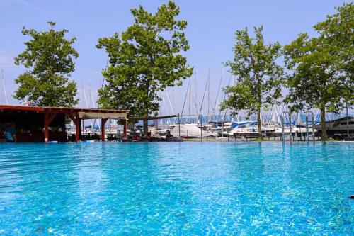 a large pool of blue water in a marina at Balatonlelle Yacht Club A I15 in Balatonlelle