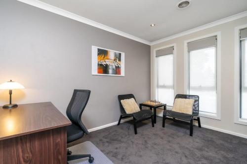 an office with chairs and a desk and windows at Superb 3BR Townhouse near Town Centre - Hosted by Canstay in Harrison