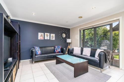 a living room with a couch and a tv at Superb 3BR Townhouse near Town Centre - Hosted by Canstay in Harrison