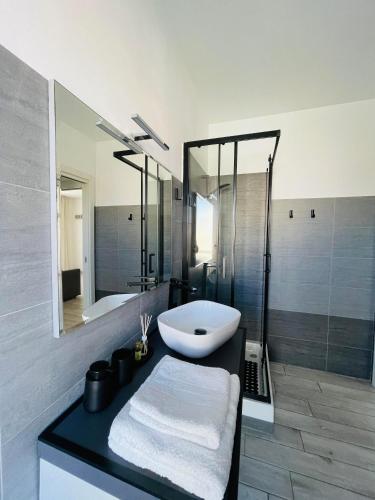 a bathroom with a white sink and a shower at Severis Apartment Fiumicino in Fiumicino