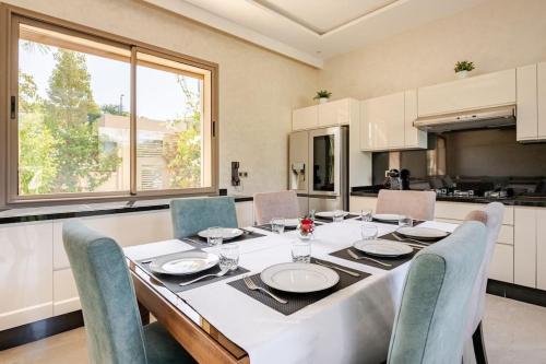 a kitchen with a table with chairs and a dining room at ZT 36 by Majestic Properties in Marrakech