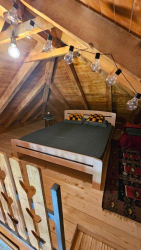 a room with a bed and a chair in a room at Eko kuća Zlatiborsko srce in Zlatibor