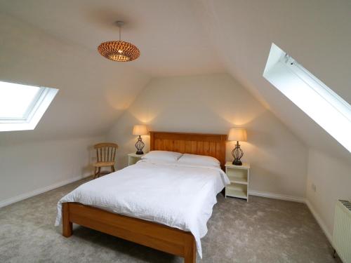 a bedroom with a bed in a attic at Glebe Farmhouse in Beaufort