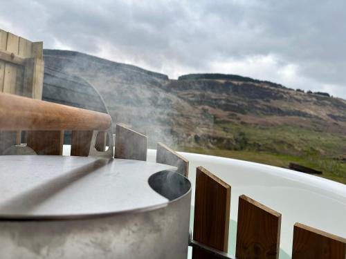 a round table with a view of a mountain at Fernhill Valley Farm in Blaencwm