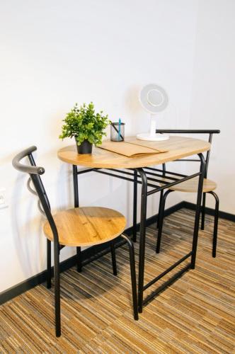 a table and a chair with a desk and a lamp at Feel Good in Ravna Gora