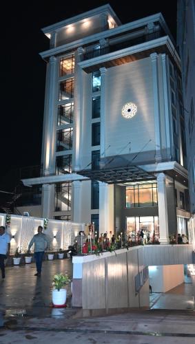 a building with a clock on the side of it at The Mudra Hotel in Varanasi