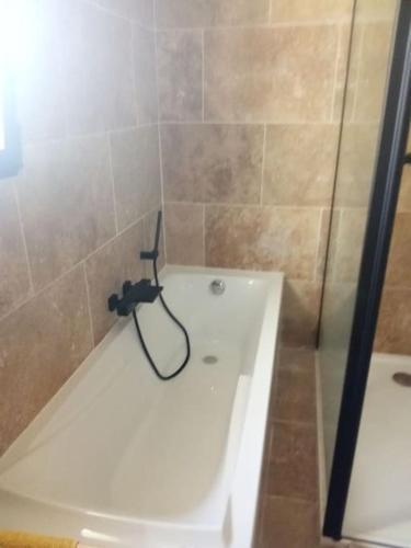 a bathroom with a shower with a white bath tub at Bastide 3 chambres 6personnes avec piscine sur Aix en Provence in Aix-en-Provence