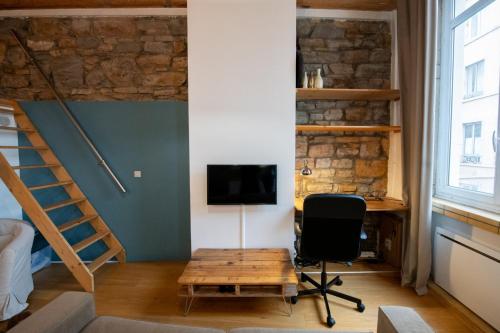 Cette chambre comprend un bureau, un ordinateur et une chaise. dans l'établissement Le petit Imbert - studio chaleureux et cozy, à Lyon