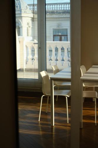 a dining room with a table and chairs and a window at Le Port Boutique Apart Hotel in Batumi