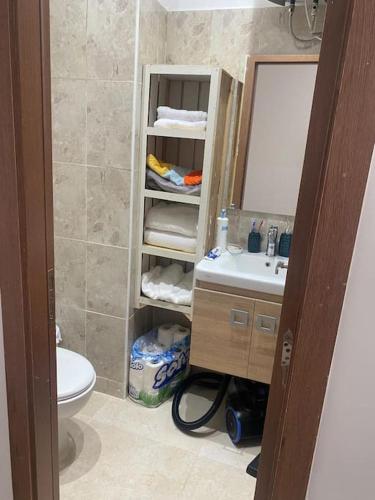 a bathroom with a sink and a toilet and a mirror at Magnifique Appart Tanger Vue Mer Plage à 100m Calme et Nature in Tangier