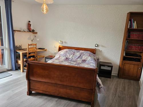 a bedroom with a bed and a desk and a table at Appartement Col de l'Arzelier in Château-Bernard