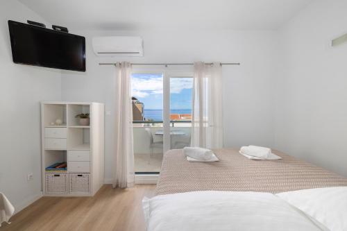 Posteľ alebo postele v izbe v ubytovaní Vidoš apartments