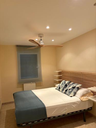 a bedroom with a bed with a ceiling fan at Holiday Paraiso in Sant Antoni de Calonge