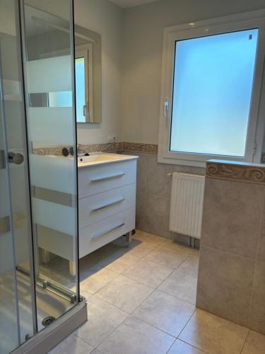 a bathroom with a sink and a glass shower at Holiday Paraiso in Sant Antoni de Calonge