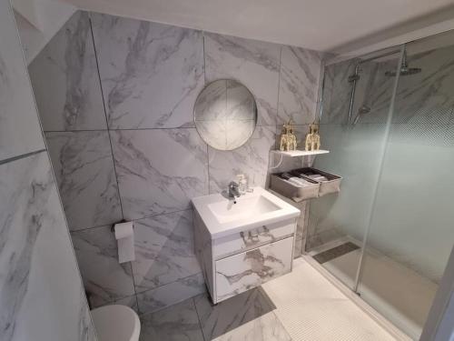 a bathroom with a sink and a shower at La joie de vivre in Seugy