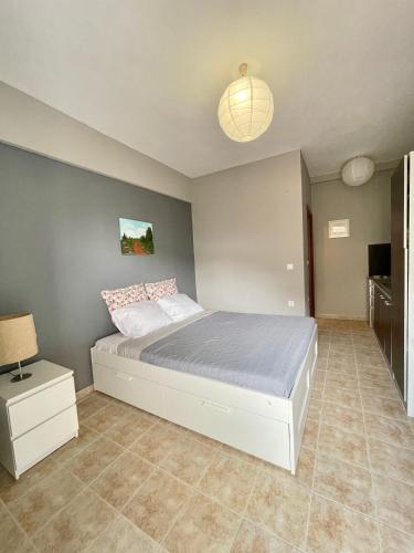 a bedroom with a large bed in a room at Souzana Suite Leptokarya in Leptokarya