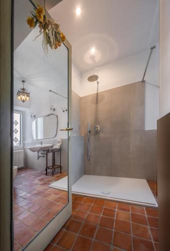 a bathroom with a shower with a glass door at Villa Clodia Relais in Manziana