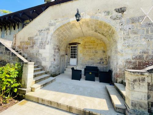 an entrance to a building with stairs and a door at Domaine Jeanne de Laval in La Bohalle