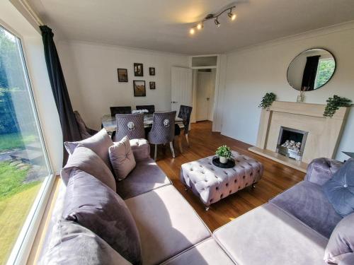 a living room with a couch and a fireplace at Free Parking Home In Gatley by City SuperHost in Baguley