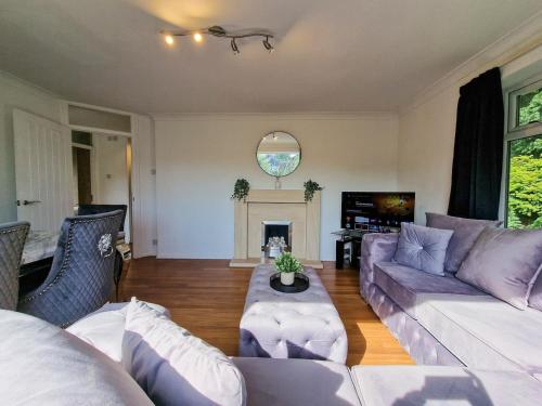 a living room with two couches and a fireplace at Free Parking Home In Gatley by City SuperHost in Baguley
