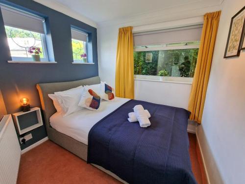 a bedroom with a bed with a teddy bear on it at Free Parking Home In Gatley by City SuperHost in Baguley