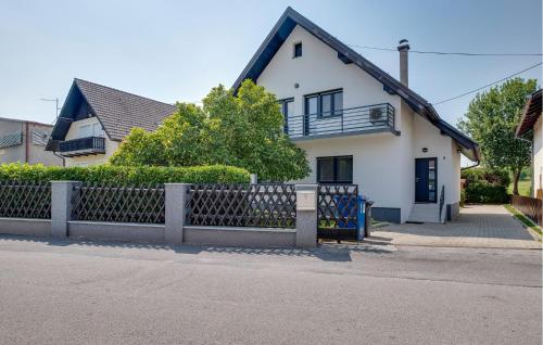 a white house with a fence in front of it at Nice Home In Stubicke Toplice in Stubicke Toplice