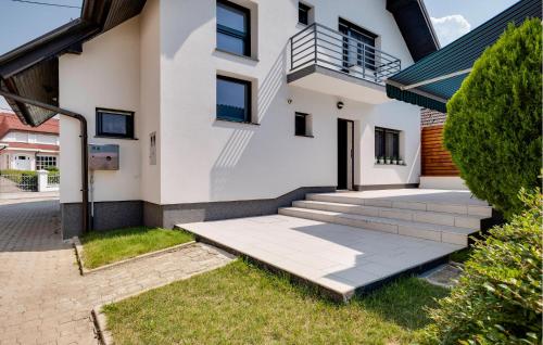 a white house with stairs in front of it at Nice Home In Stubicke Toplice in Stubicke Toplice