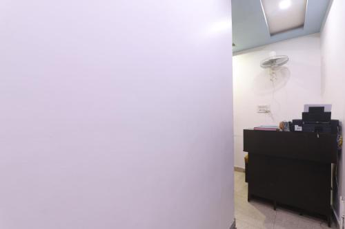 a room with a desk and a fan on a wall at Metro Regency - Near Hazratganj & Charbagh in Lucknow