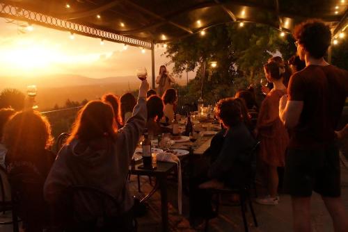 a group of people sitting at a table at a party at Agriturismo Cafaggio Primo in Loro Ciuffenna