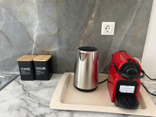 a red coffee maker sitting on a counter at ENE’S Mýkonos in Klouvas